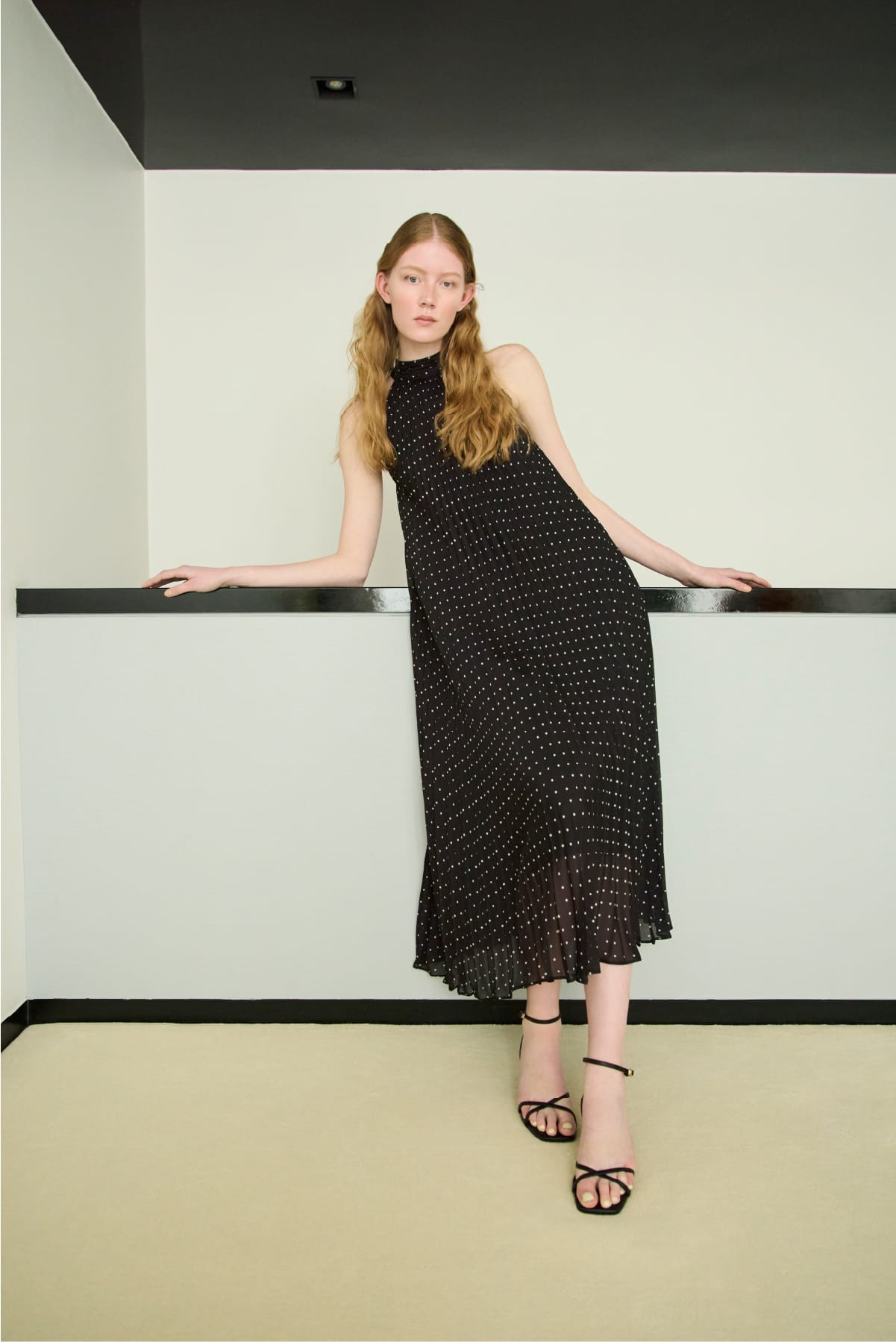 黒のドットのワンピースを着用した女性