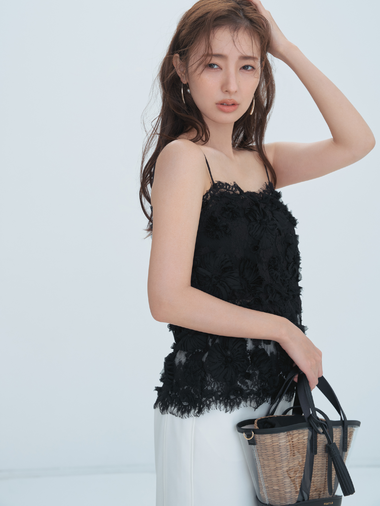 フラワーエンブロイダリーレースキャミソール・Iラインストレートスカート・パールフープピアス・【BAGMATI】ビニールカゴバッグ(別注カラー)を着用した女性