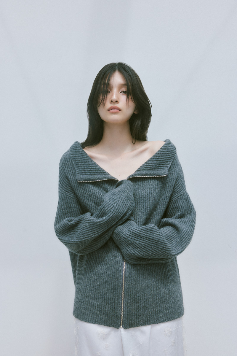2wayオフショルスキッパージップニットを着用した女性の上半身