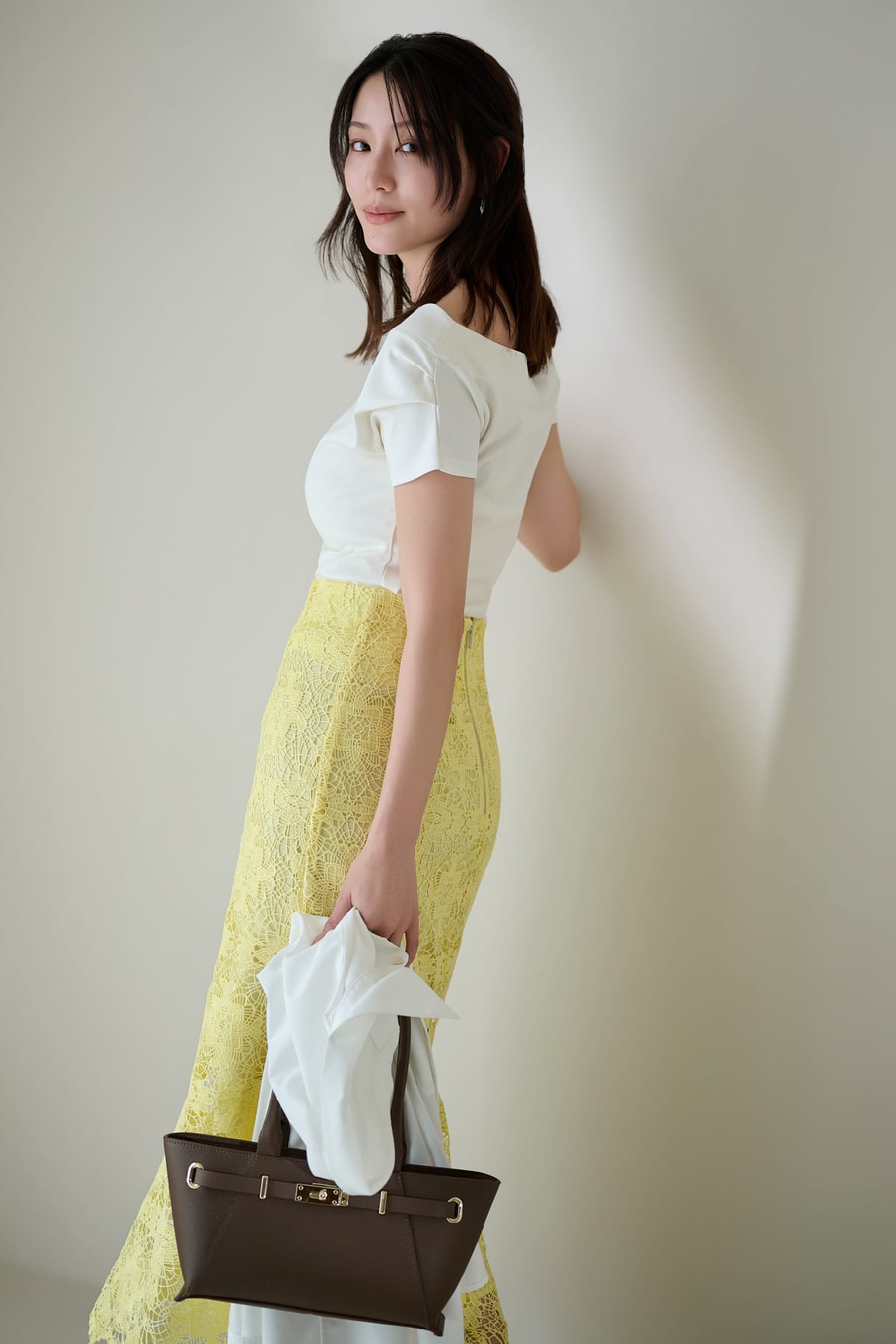 白のシャツに黄色のスカートを着用している女性